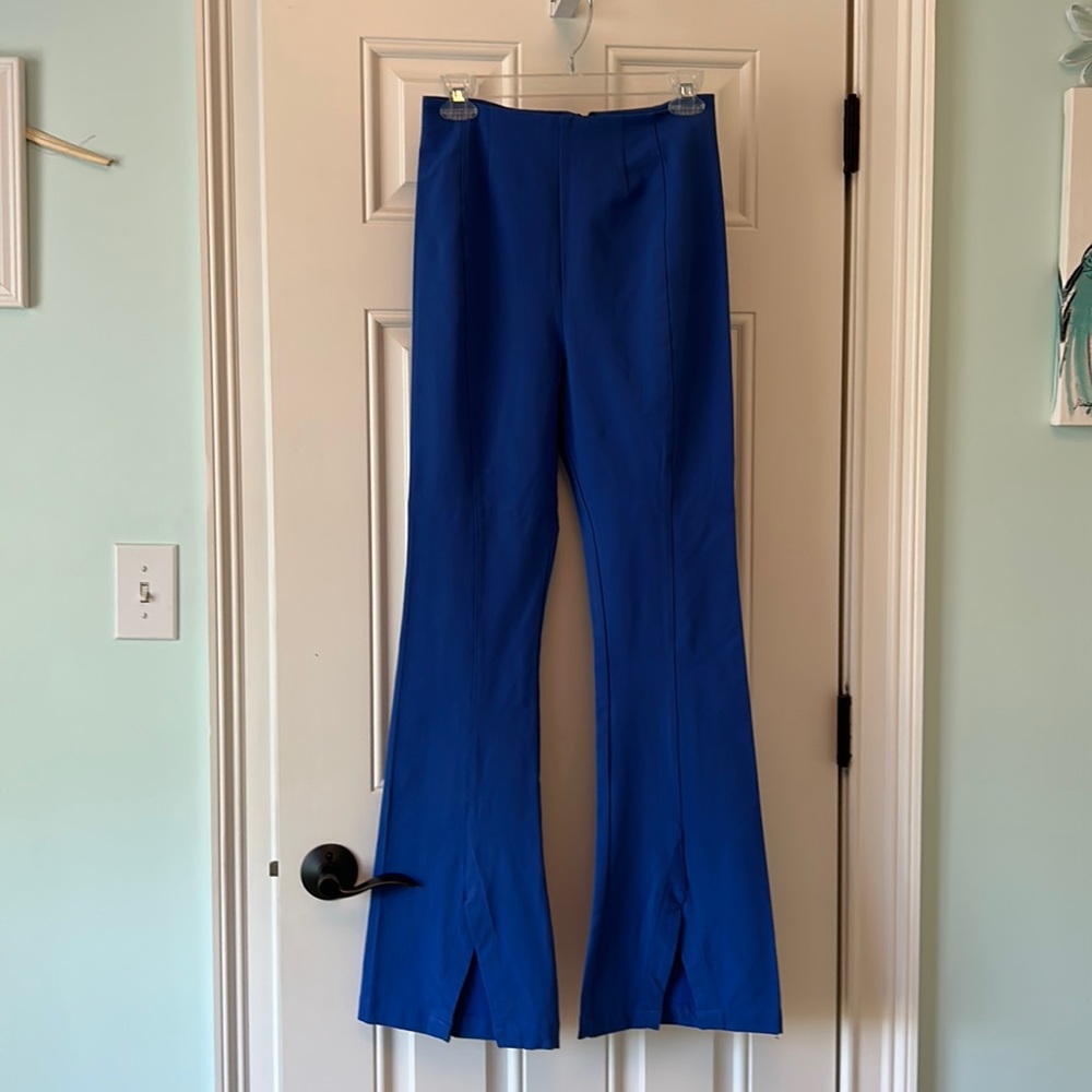 Free People high waisted pant with back zipper and v cut outs at pant bottom.
